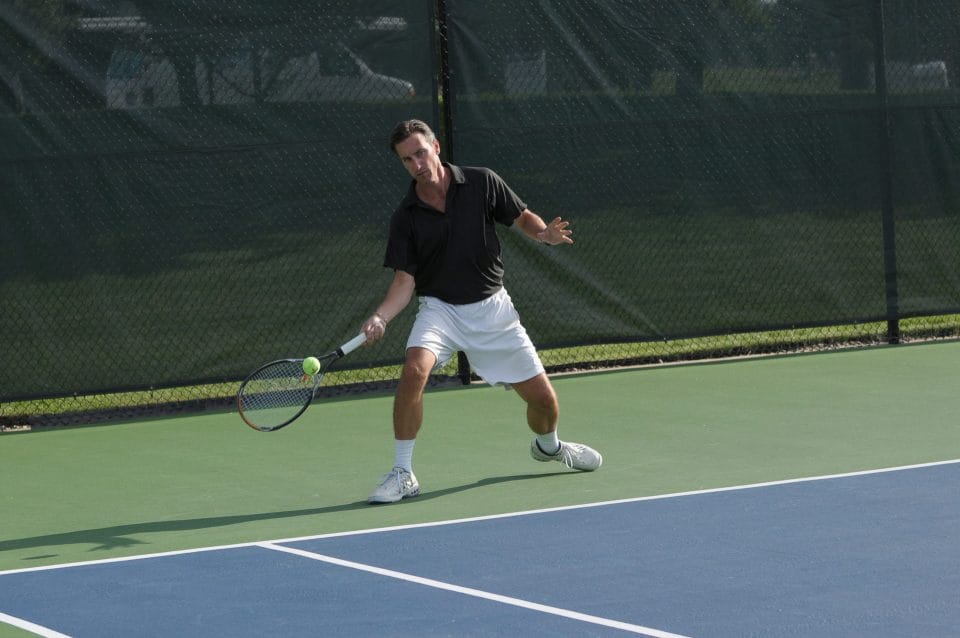 Theo club greenwood tennis pro playing tennis on outdoor courts